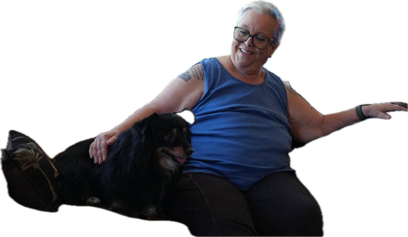 Janet Hardy seated with a black dog